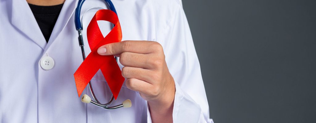 The doctor holds a red ribbon, HIV awareness awareness, World AIDS Day and World Sexual Health Day.